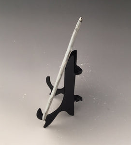side view showing black metal stand